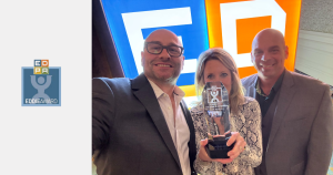 Matt Andrews, Brian Baker, and Debbie Parrott holding EDDIE award trophy
