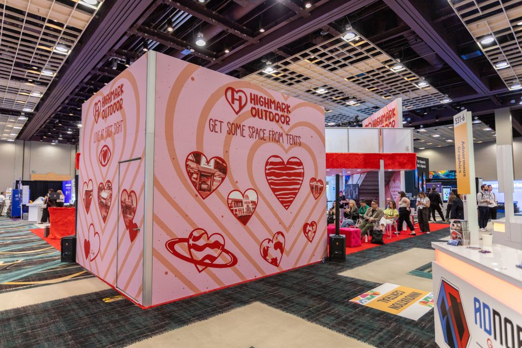 Exterior of Highmark EMS structure with pink heart-patterned walls reading “Get some space from tents”